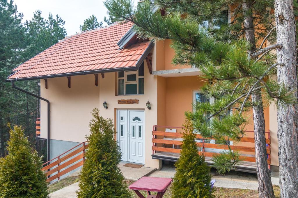 a small house with a red roof at Mountain House Tara Apartmani Nikolic in Kaludjerske Bare