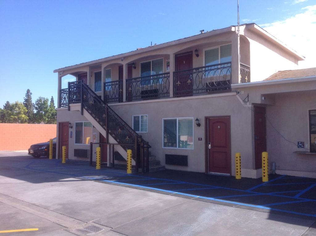 a building with a staircase on the side of it at Sun Light Motel in Downey