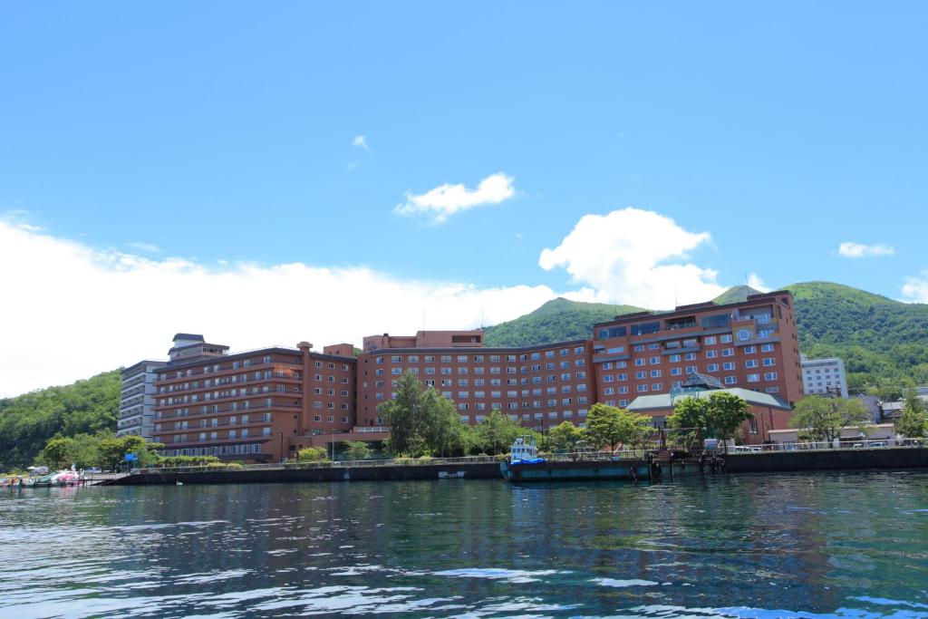 a view of a city from the water at Toyako Manseikaku Hotel Lakeside Terrace in Lake Toya