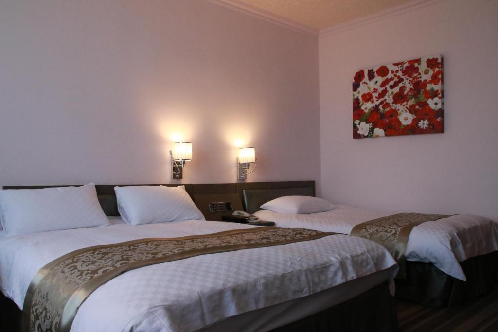 Postel nebo postele na pokoji v ubytování Hotel River Kinmen