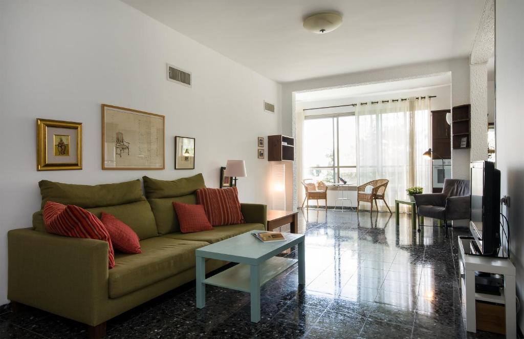 a living room with a couch and a table at Eshkol Housing Carmel Center: Forest retreat in Haifa