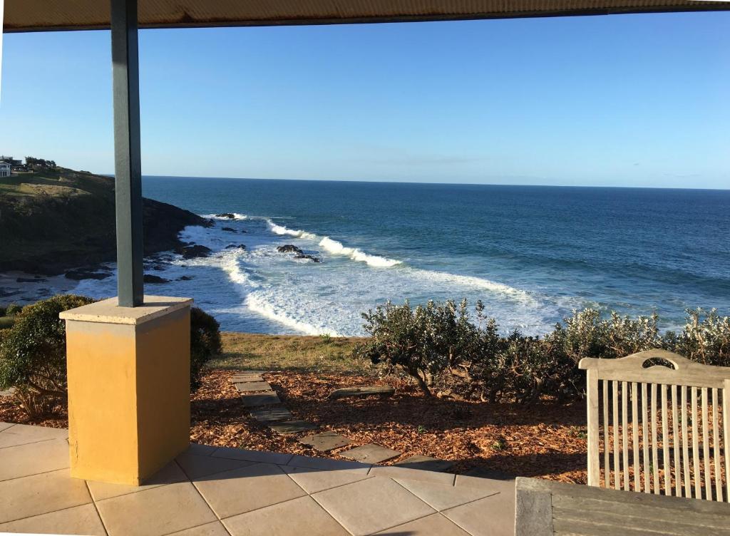 a view of the ocean from the porch of a house at OceanScape Luxury Beachfront Villas in Scotts Head