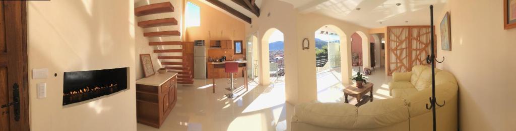 a living room with a person sitting on a couch at Magnolias Boutique Suites & SPA in San Cristóbal de Las Casas