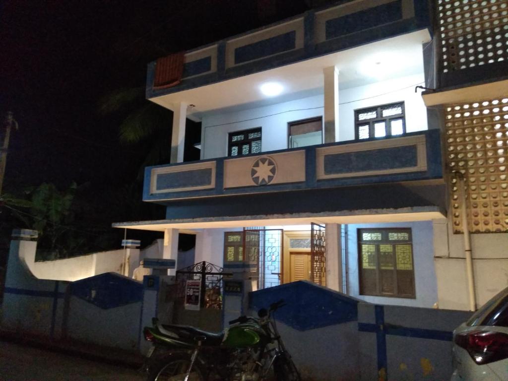 a building with a motorcycle parked in front of it at vacation Home Stay in Pondicherry