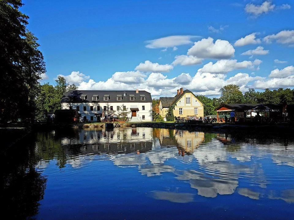 a reflection of buildings in the water of a river at Panský mlýn in Opava