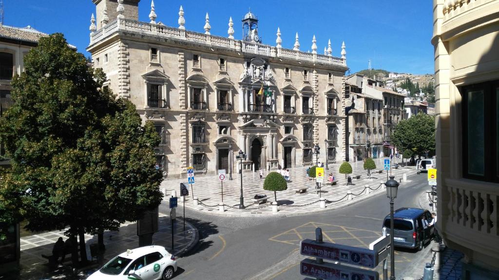 a large building with cars parked in front of it at Donde Antonio in Granada