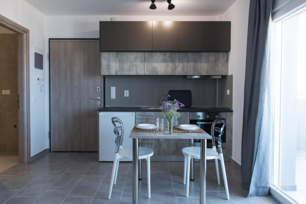 a kitchen and dining room with a table and chairs at House Okto in Alexandroupoli