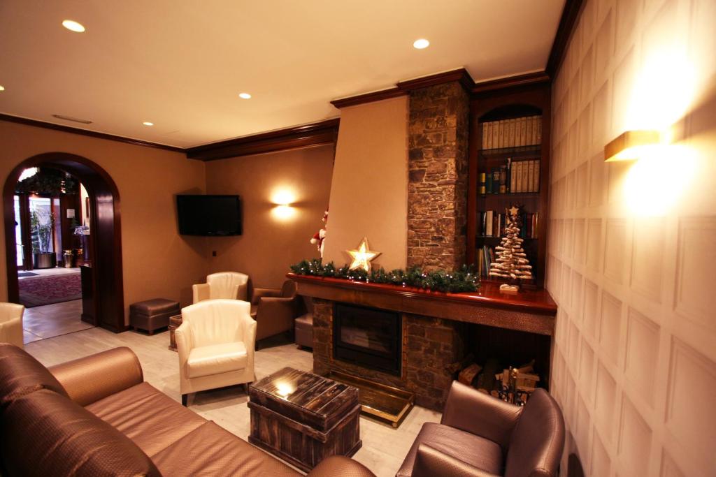 a living room filled with furniture and a fireplace at Hotel Pyrénées in Andorra la Vella