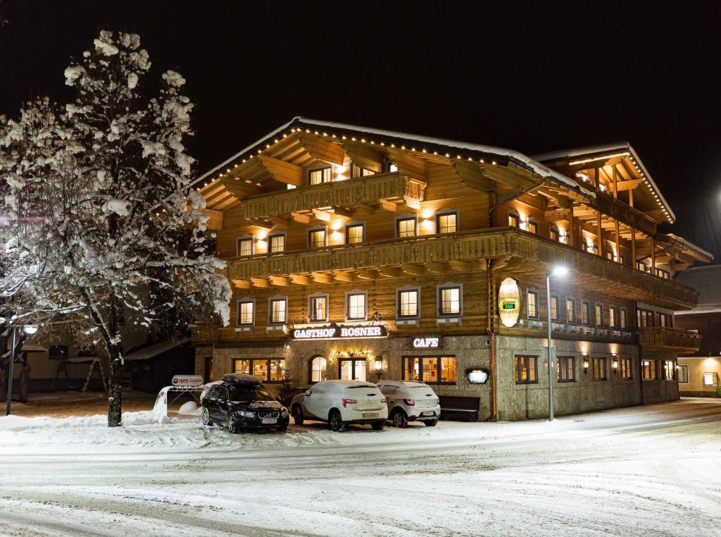 a large building with cars parked in front of it at Hotel Rosner in Altenmarkt im Pongau