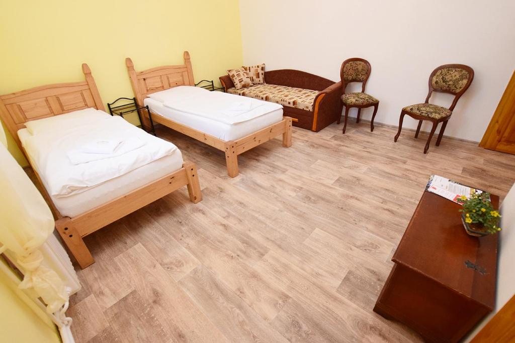 Postel nebo postele na pokoji v ubytování Penzion Klášter