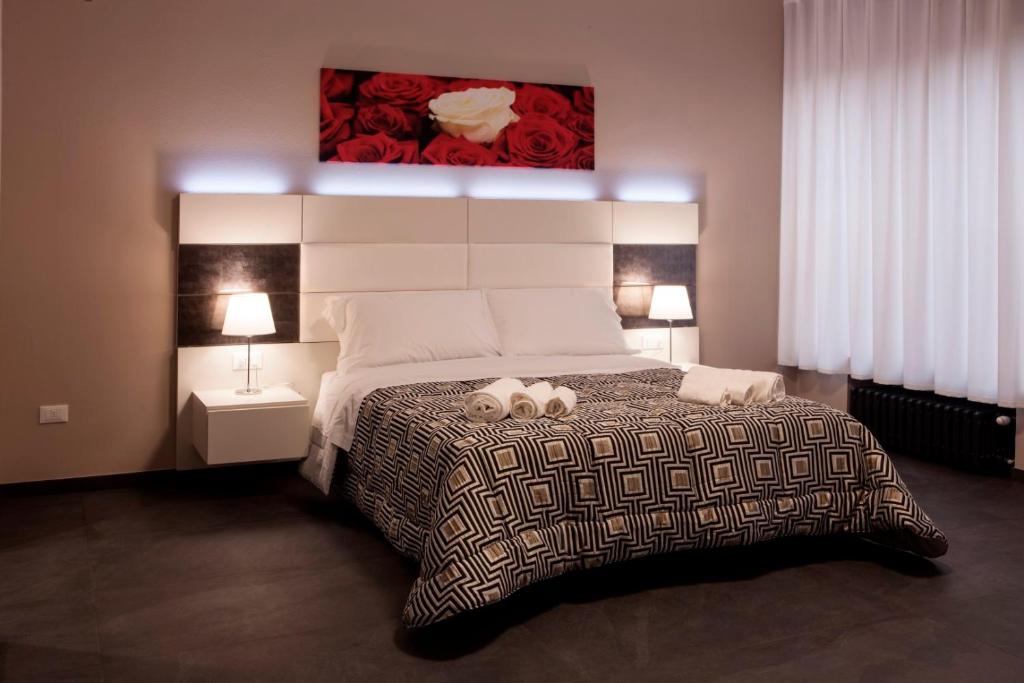 a bedroom with a large bed with two pillows on it at Living Arena in Verona