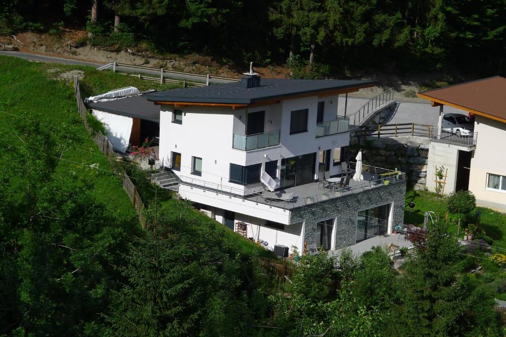 an aerial view of a white house on a hill at Birnbacher-appartement in Sankt Veit im Pongau