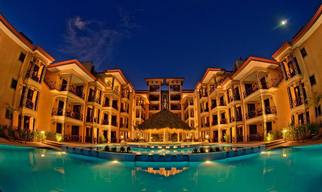 a building with a pool of water in front of it at Bahia Encantada beach front proyect, Jaco Paradise in Jacó