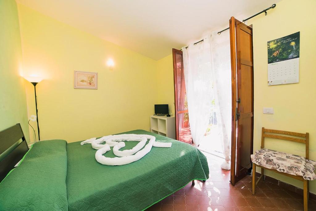 Łóżko lub łóżka w pokoju w obiekcie B&B Bouganville