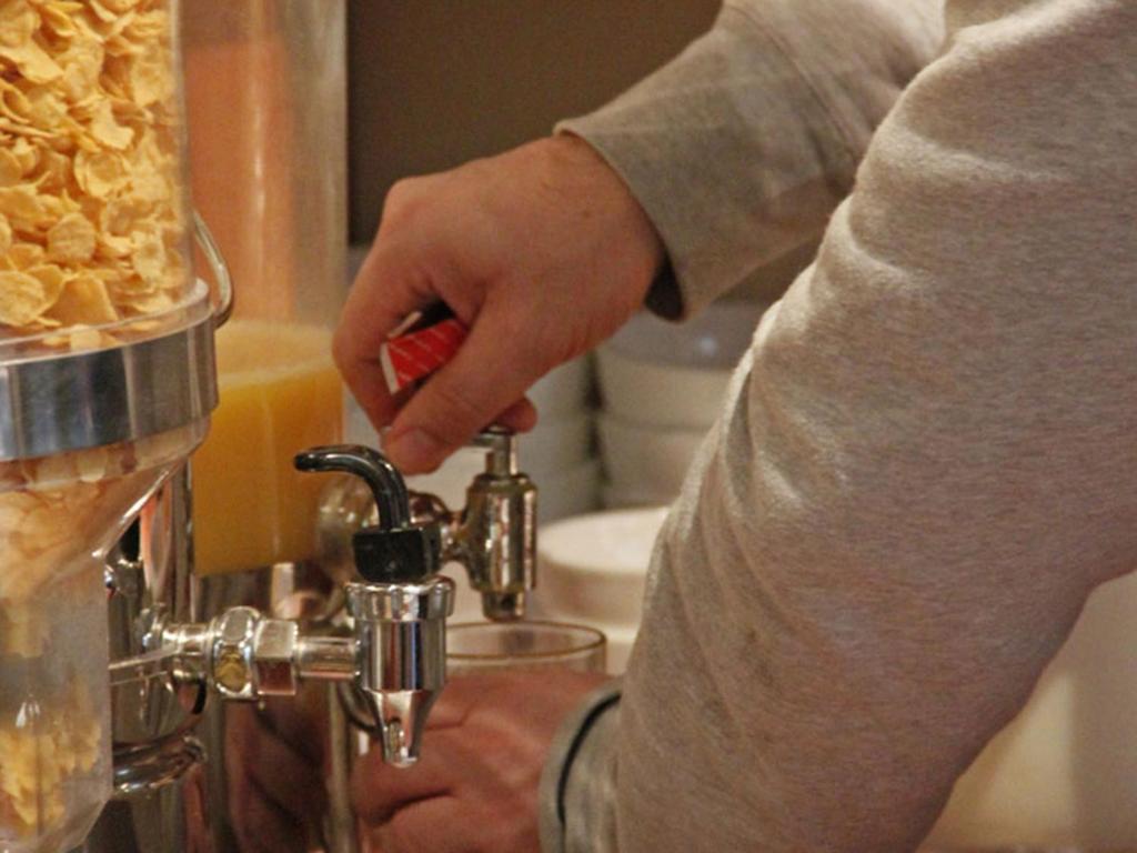 a person pouring something into a blender at A-Train Hotel in Amsterdam