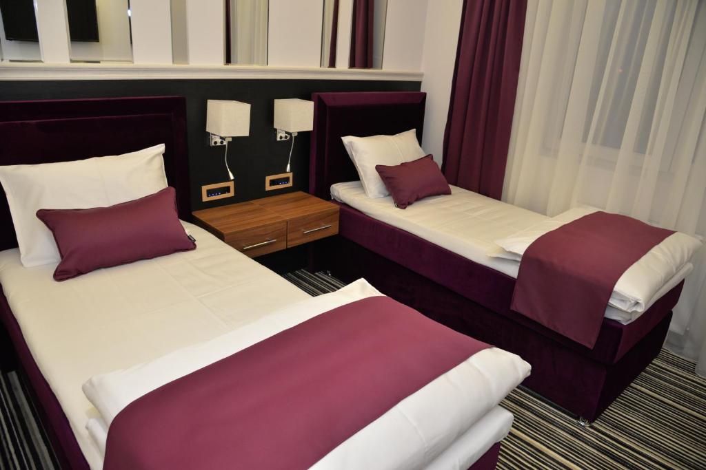 Postel nebo postele na pokoji v ubytování Hotel Prezident