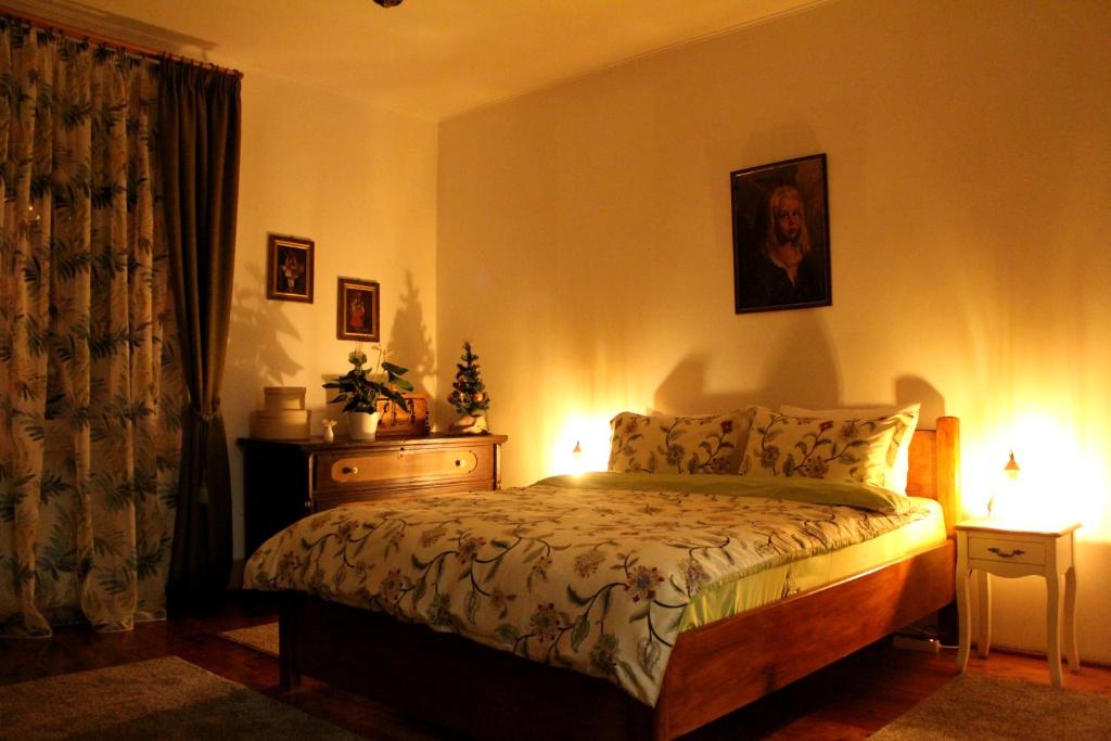 a bedroom with a bed and a dresser with lights at La Bella in Sibiu