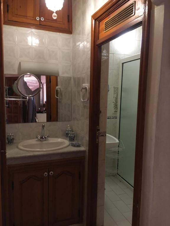 a bathroom with a sink and a mirror and a tub at Zina in Marrakesh