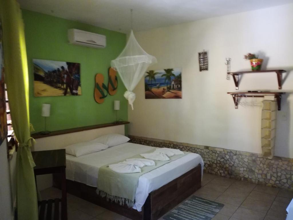 Ένα ή περισσότερα κρεβάτια σε δωμάτιο στο Pousada Brisa & Soul