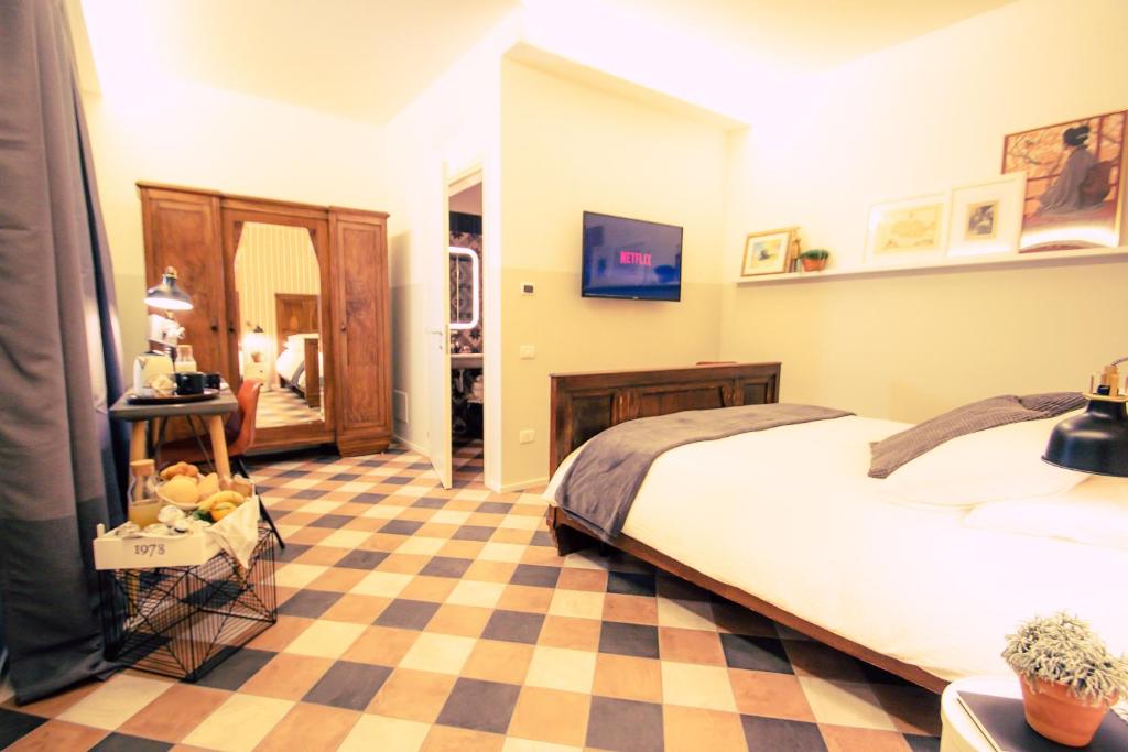 a bedroom with a bed and a checkered floor at Arsenale Suites in Verona