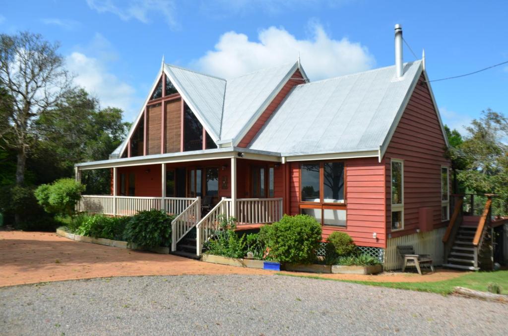 a red house with a metal roof at Ruddles Retreat in Maleny