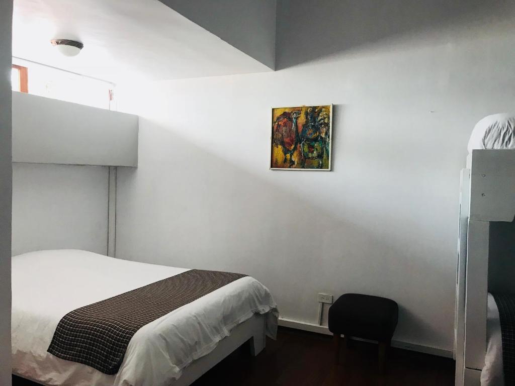 Postel nebo postele na pokoji v ubytování Hostal Posada del Maple