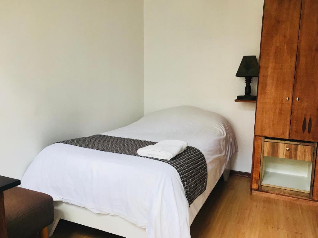 Postel nebo postele na pokoji v ubytování Hostal Posada del Maple