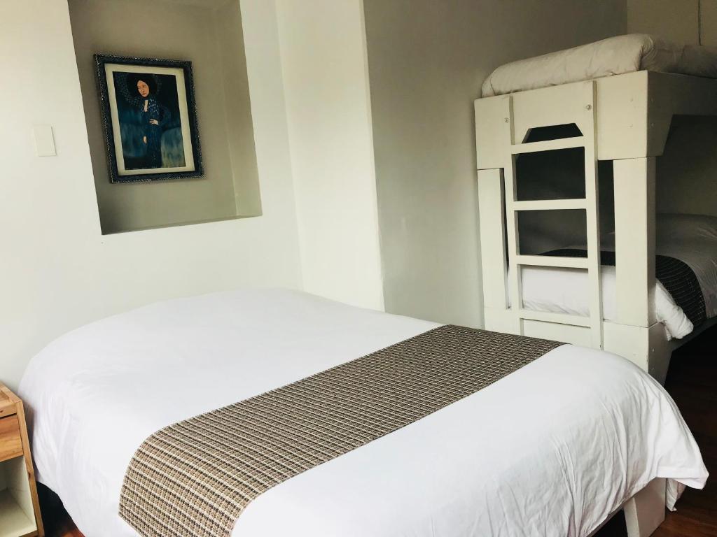 Postel nebo postele na pokoji v ubytování Hostal Posada del Maple