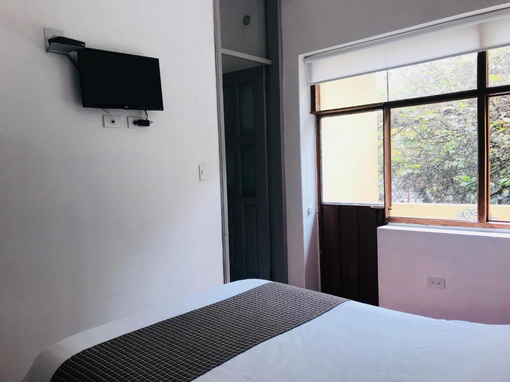 Postel nebo postele na pokoji v ubytování Hostal Posada del Maple