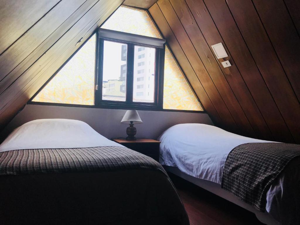 Postel nebo postele na pokoji v ubytování Hostal Posada del Maple