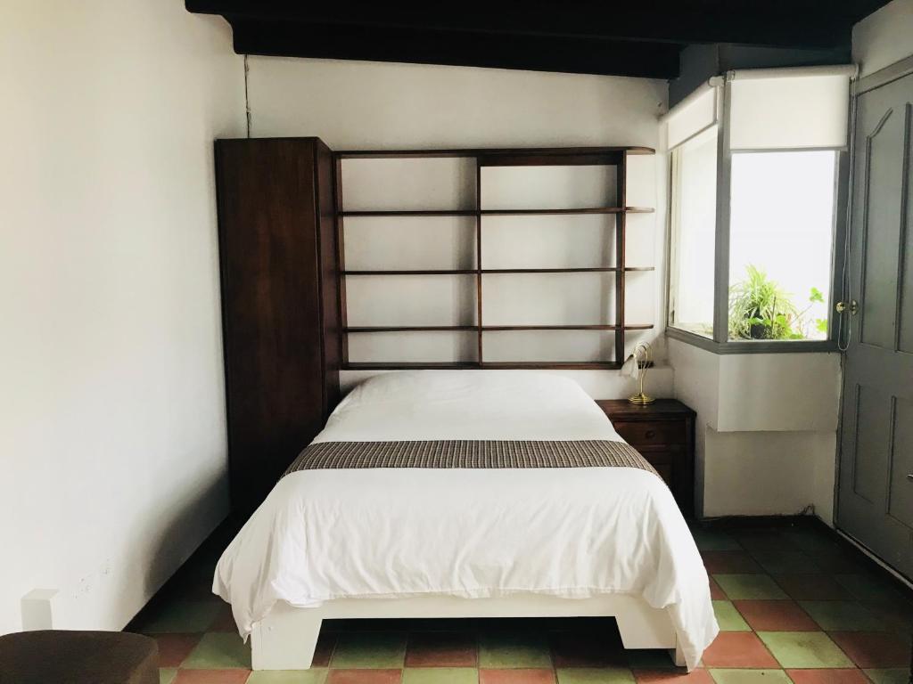 Postel nebo postele na pokoji v ubytování Hostal Posada del Maple