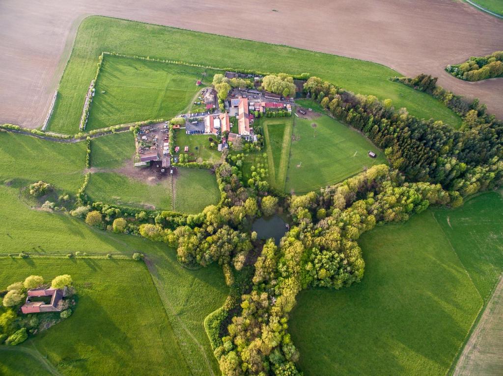 an aerial view of a large house on a green field at Penzion Farma Dvorec in Radnice