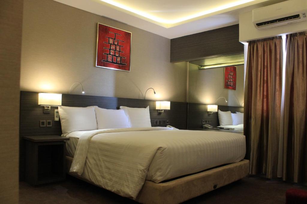 Postel nebo postele na pokoji v ubytování Biz Hotel Batam