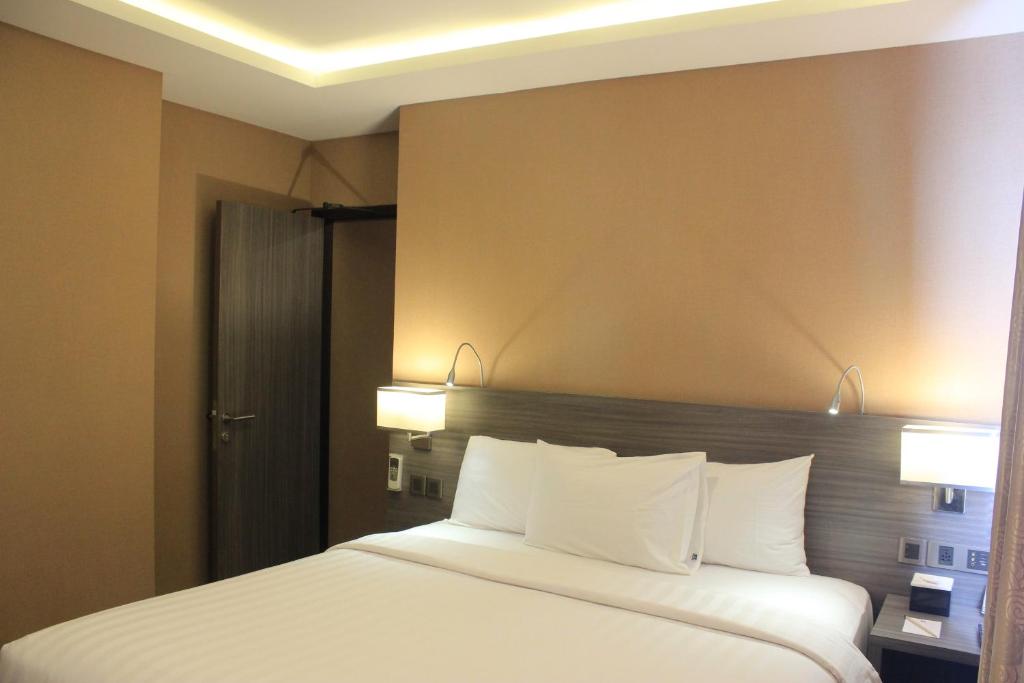 Postel nebo postele na pokoji v ubytování Biz Hotel Batam