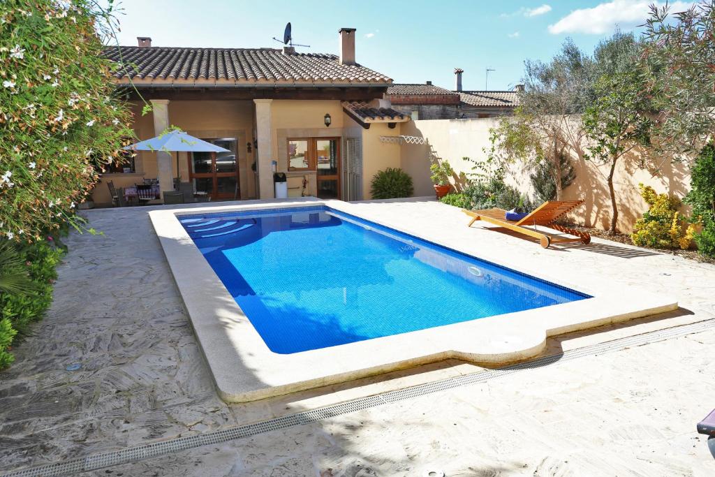 a swimming pool in the backyard of a house at Flowers House in Maria de la Salut