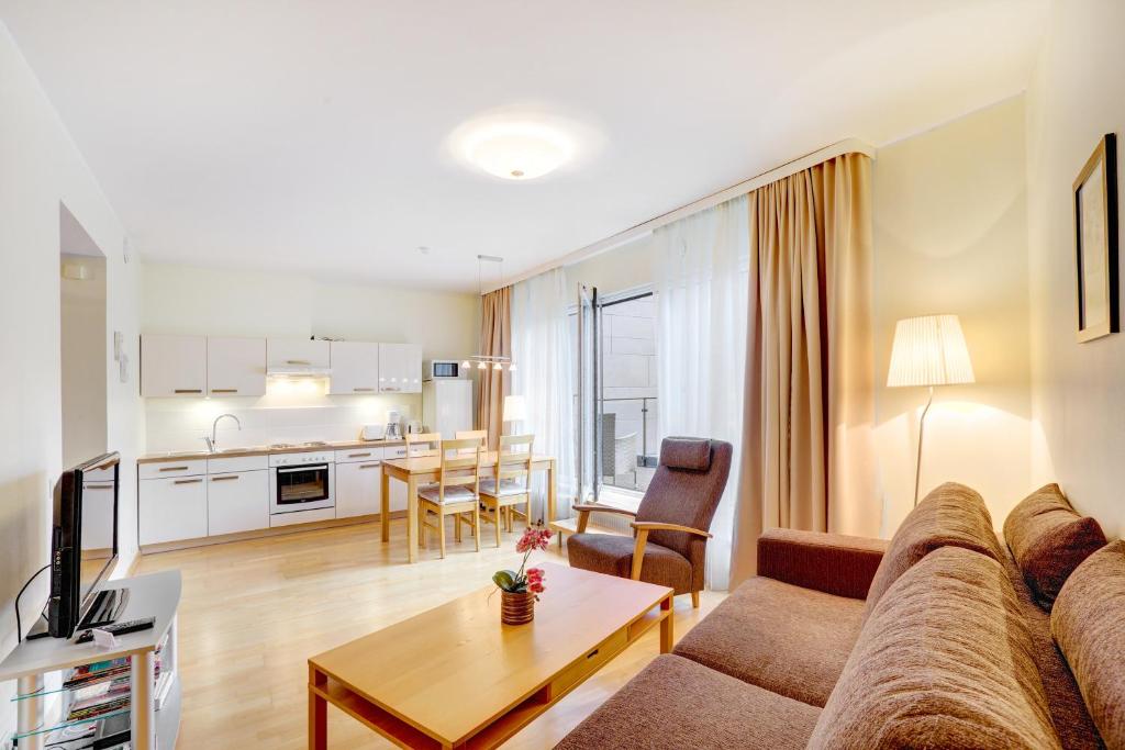 a living room with a couch and a table at Apartment24 - Foorum in Tallinn