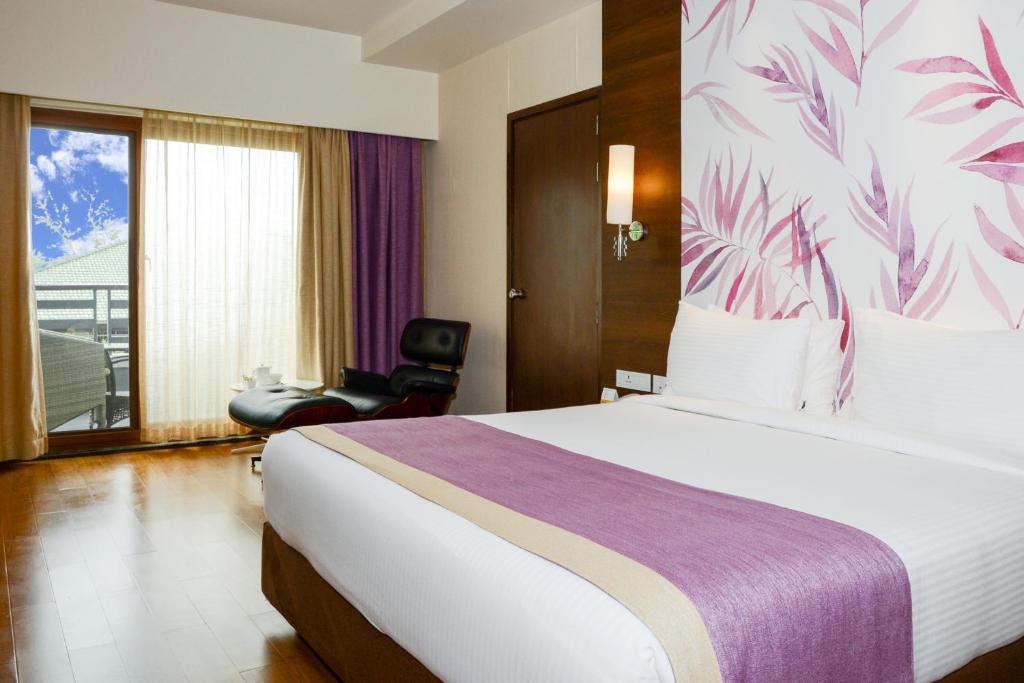Postel nebo postele na pokoji v ubytování Purple Palms Resort & Spa