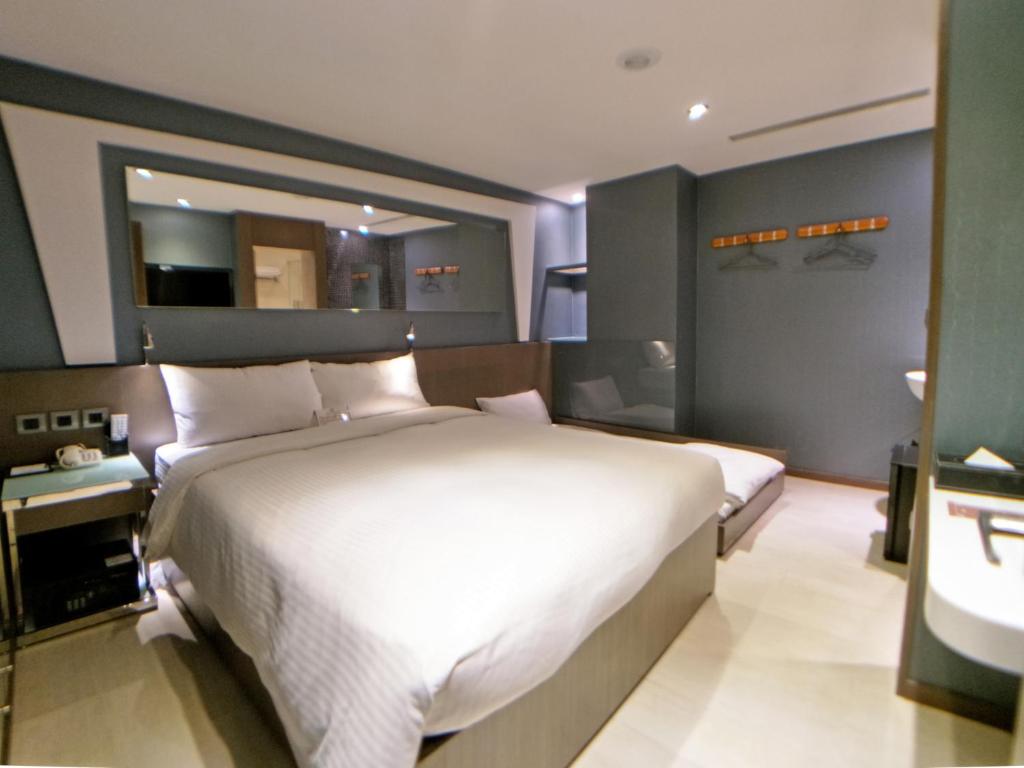 Ένα ή περισσότερα κρεβάτια σε δωμάτιο στο Beauty Hotels Taipei - Hotel B6