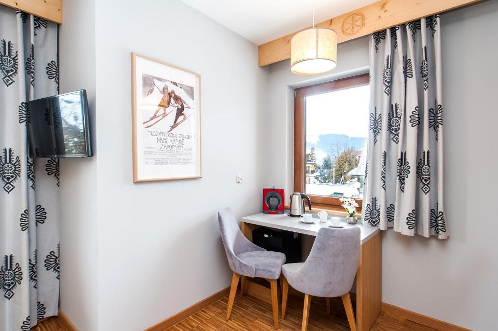 Televízia a/alebo spoločenská miestnosť v ubytovaní Apartamenty Sun & Snow Resorts Lipki Park z sauną