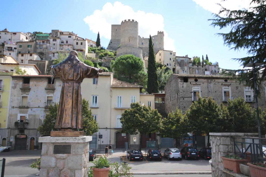 a statue in front of a city with a castle at Universal Apartments Itri C in Itri