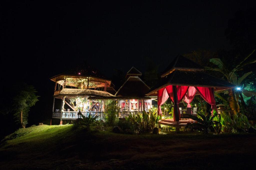a house at night with a lit up at Shangri-Lao Resort in Luang Prabang