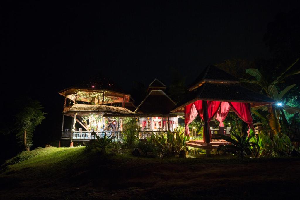 a house at night with a lit up at Shangri-Lao Resort in Luang Prabang