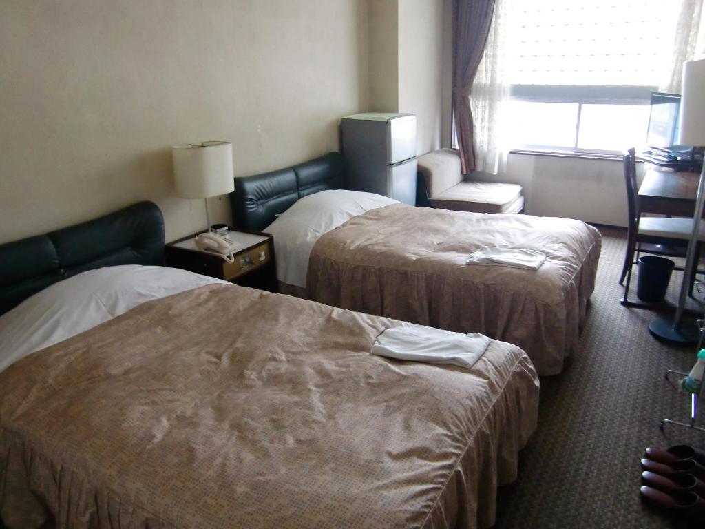 Postel nebo postele na pokoji v ubytování Ryogoku River Hotel