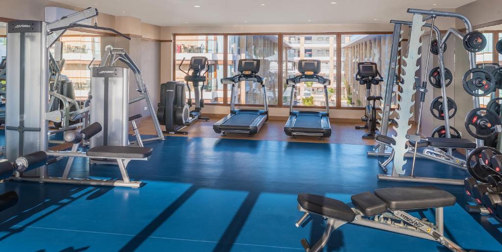 a gym with a blue floor and tread machines at Henann Crystal Sands Resort in Boracay
