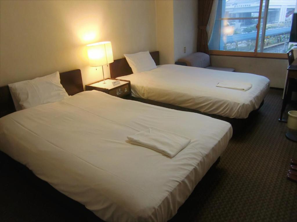 Postel nebo postele na pokoji v ubytování Ryogoku River Hotel