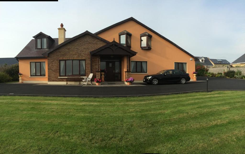 a house with a car parked in front of it at Seanor House Bed & Breakfast in Ballybunion