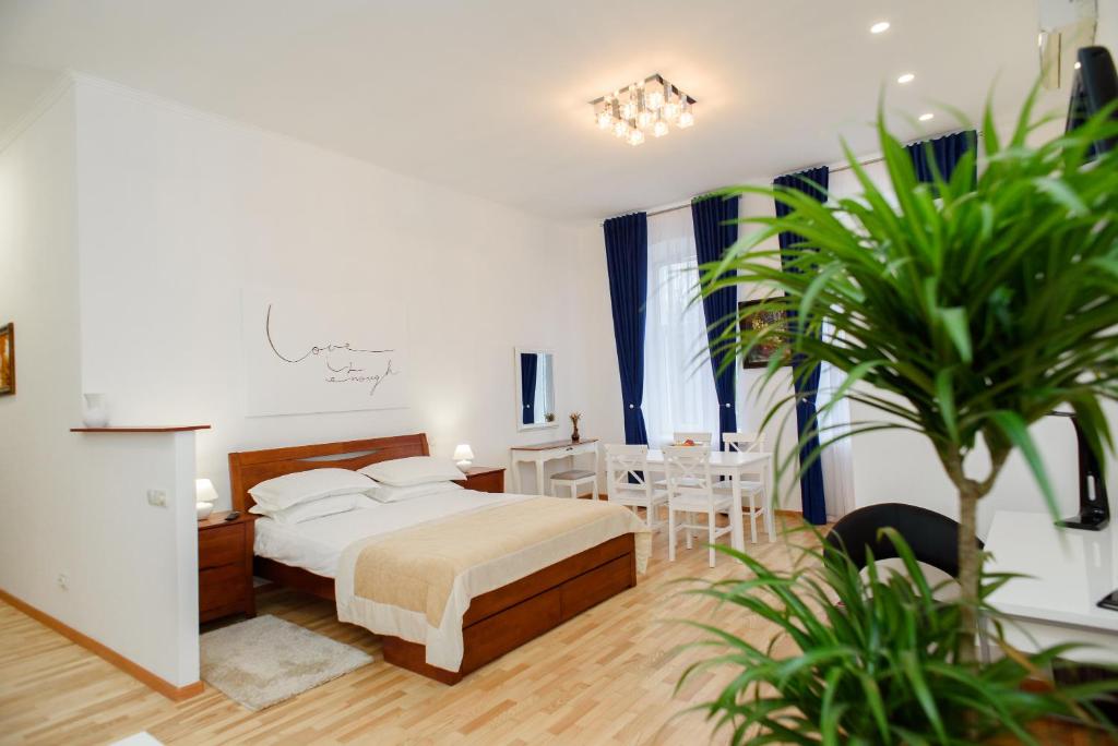 - une chambre avec un lit, une table et des chaises dans l'établissement M&M Aparthotel VIP, à Soumy