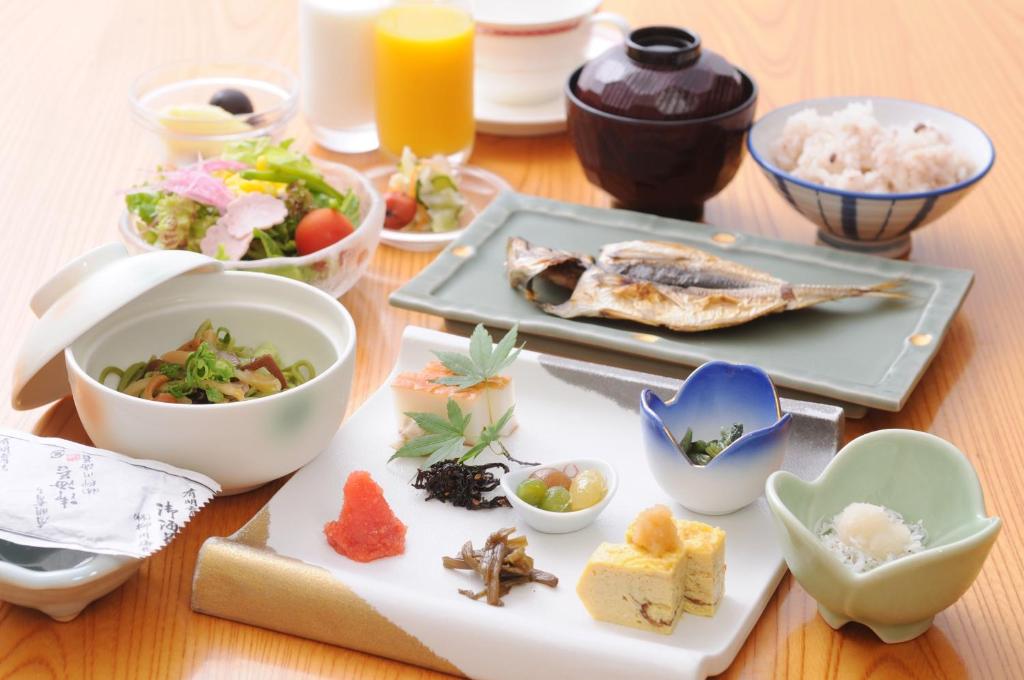a table with plates of food and bowls of food at Lalaca in Hakone