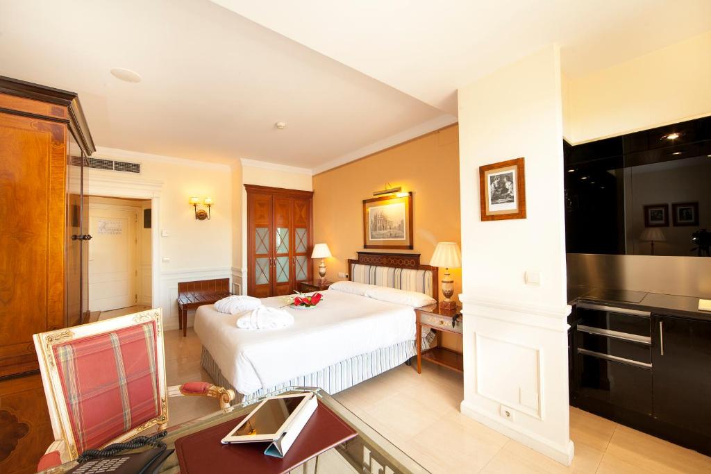 a hotel room with a bed and a kitchen at Apartamentos Guadalpin Boutique in Marbella