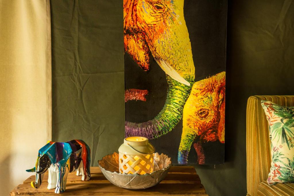 a table with a bowl and an elephant blanket at Mahoora Wilpattu - by Eco Team in Wilpattu